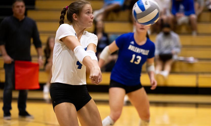 High school students play volleyball